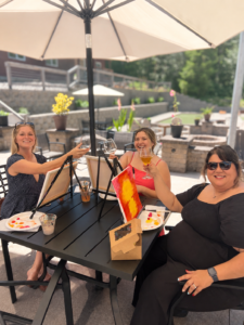 a group of women cheers each other over paintings and canvas in a public paint and sip event in washington
