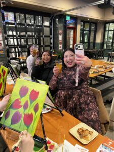 Friends painting together during a private birthday paint party in Western Washington
