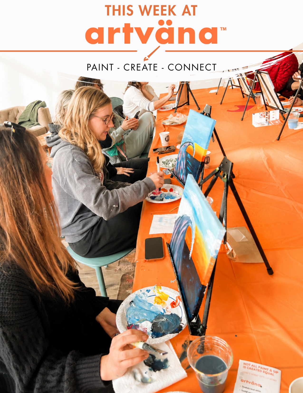 people painting together at a large artvana paint and sip class